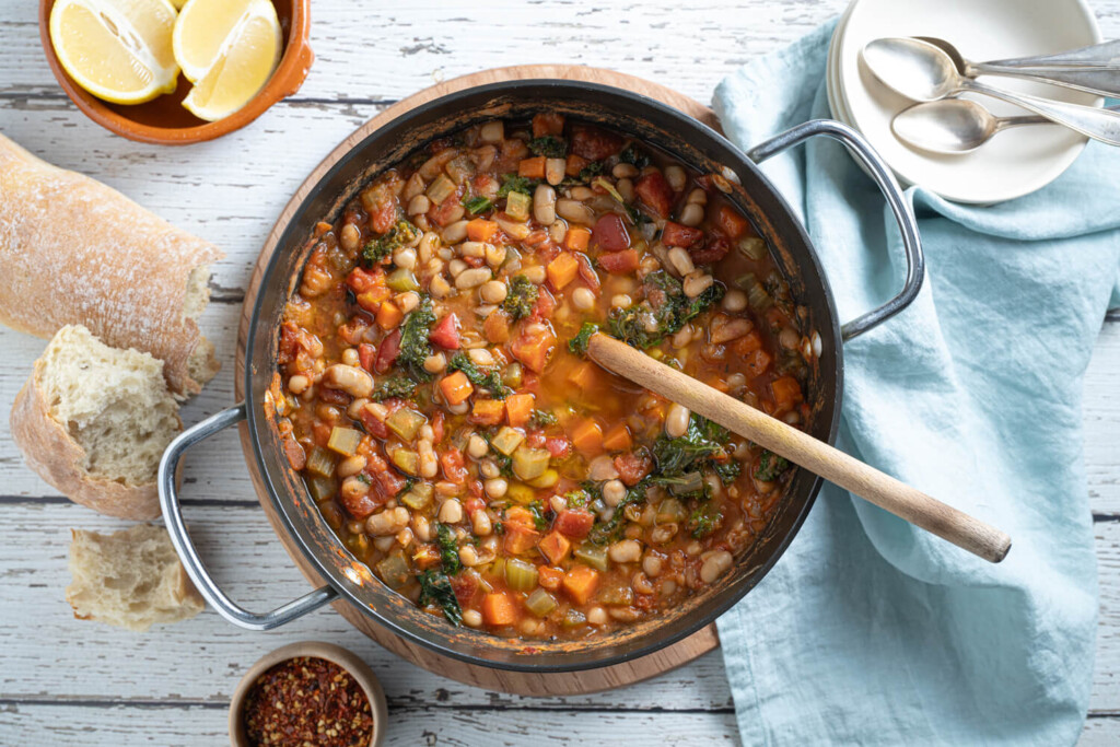 Overhead image of pot of Tuscan white bean stew with kale