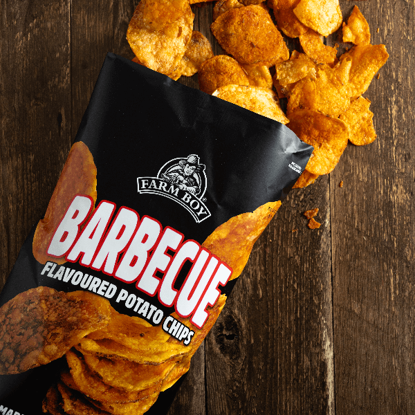 Pantry staple: Farm Boy Barbecue Potato Chips spilling out of bag onto dark wooden table