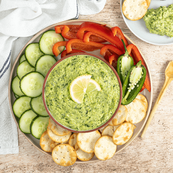 Overhead image of plate of vegetables and crackers with bowl of Farm Boy Spicy Kale Eda-Yummy Dip.