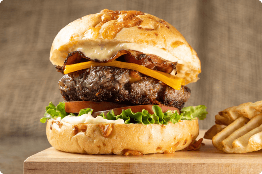 Indulge in the rich and savory delight of a Bacon Cheddar burger where the patty is crafted from fresh, high-quality steak.