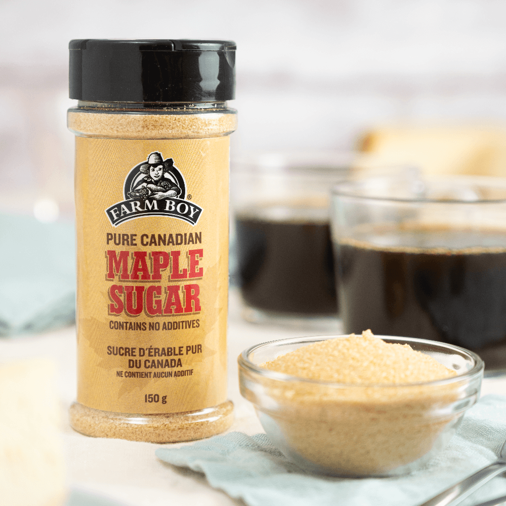 Shaker bottle of Farm Boy™ Pure Canadian Maple Sugar next to small glass bowl filled with maple sugar.