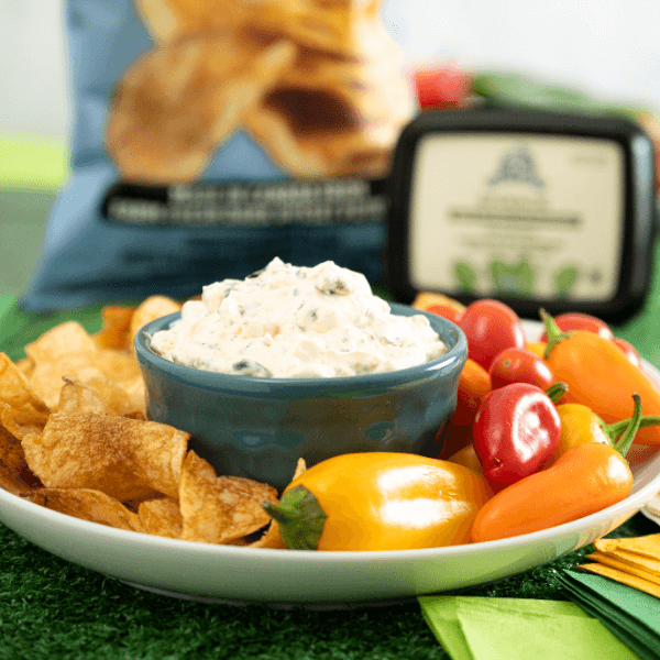 Plate of chips and veggies with bowl of Farm Boy Spinach Dip.